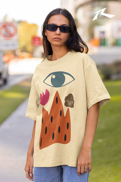 Woman wearing a beige t-shirt with colorful designs outdoors