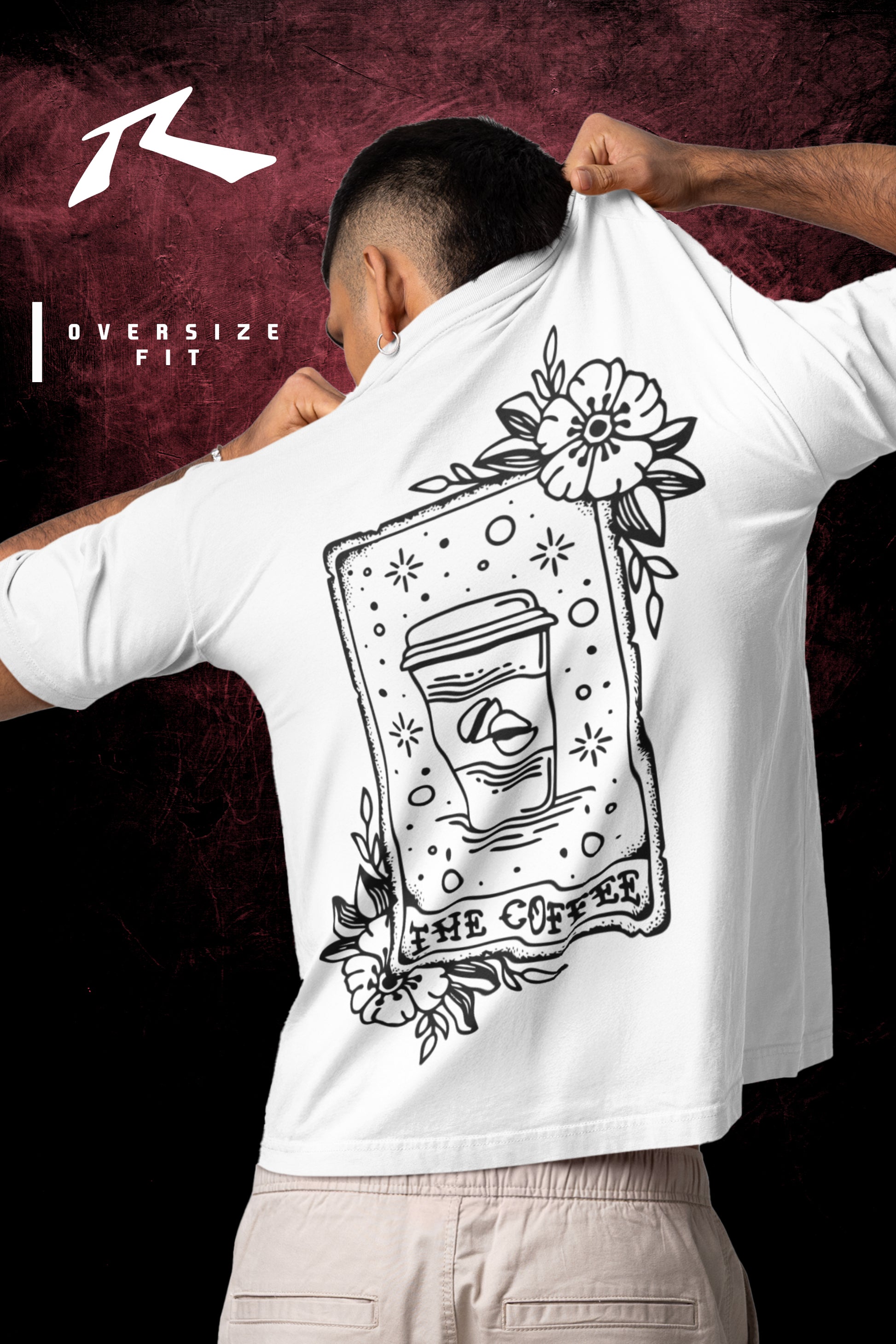 Person wearing a white t-shirt with a black graphic design on the back, against a dark background.