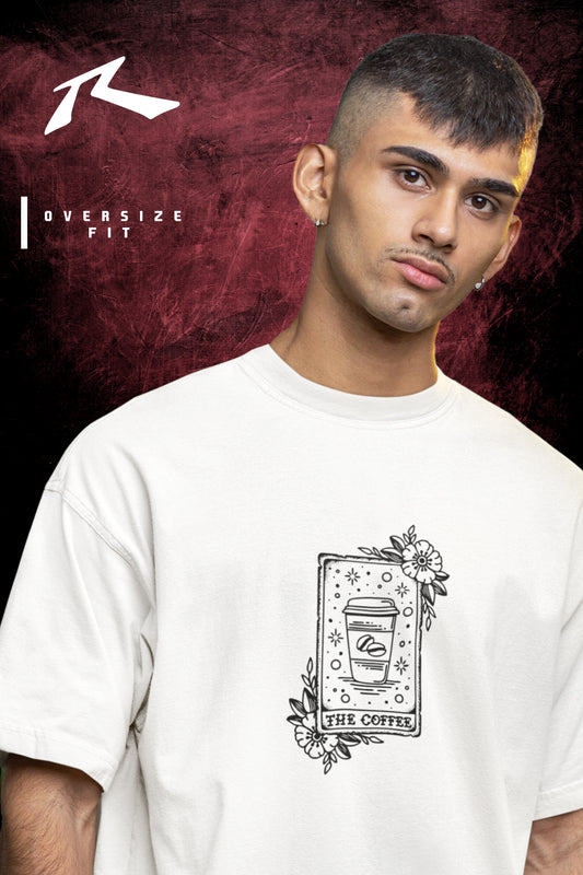 Person wearing a white t-shirt with a graphic design on a dark background