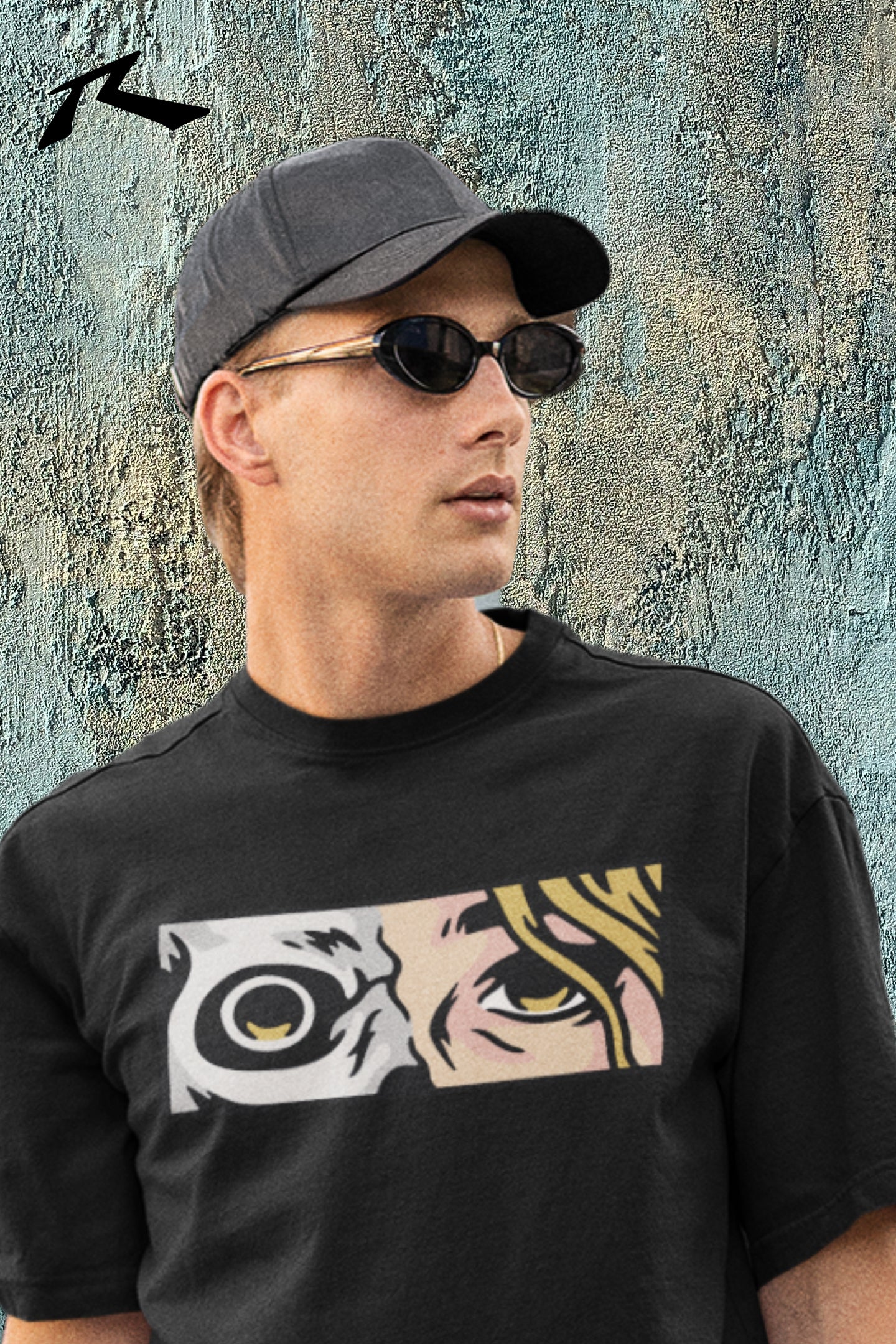 Man wearing a black t-shirt with a graphic design, sunglasses, and a cap against a textured wall.