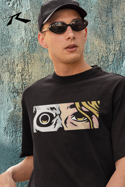 Person wearing a black t-shirt with a graphic design, standing against a textured wall.